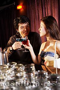 Asia Images Group - Young couple having drinks at night club