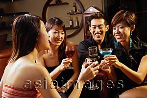 Asia Images Group - Friends in entertainment club, toasting with drinks