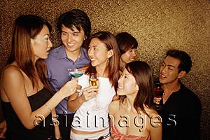 Asia Images Group - Young adults holding drinks, smiling and talking