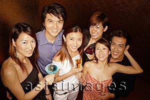 Asia Images Group - Young adults holding drinks, looking up at camera
