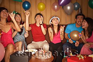 Asia Images Group - Young adults celebrating, looking up at balloons