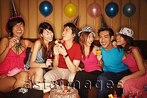 Asia Images Group - Young adults sitting side by side, celebrating
