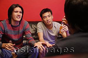Asia Images Group - Young men with beer bottles, bonding