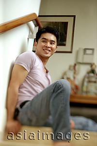 Asia Images Group - Man sitting on staircase