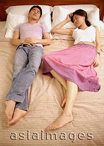 Asia Images Group - Couple sleeping on bed, side by side