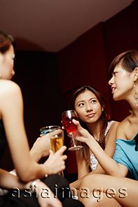 Asia Images Group - Young adults with drinks, low angle view