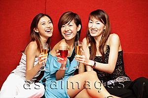 Asia Images Group - Young women with drinks, smiling at camera