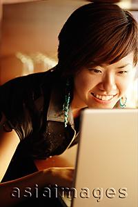 Asia Images Group - Young woman using a laptop