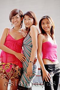 Asia Images Group - Young women standing side by side, looking at camera