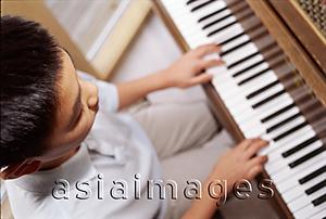 Asia Images Group - Boy sitting at piano, high angle view