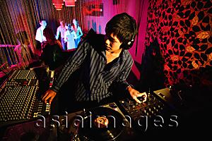 Asia Images Group - Young man spinning at club