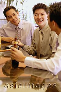 Asia Images Group - Young men at bar counter talking