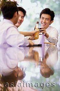 Asia Images Group - Young men with drinks, toasting