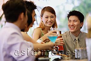Asia Images Group - Young adults at bar counter, with drinks