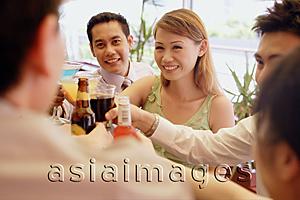 Asia Images Group - Young adults toasting with drinks