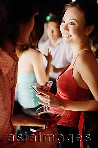 Asia Images Group - Couples at night club, talking