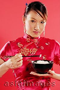 Asia Images Group - Woman holding bowl of rice and chopsticks, looking at camera
