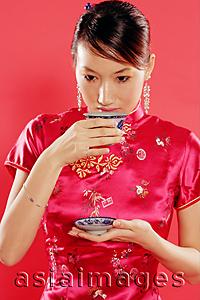Asia Images Group - Woman holding teacup, drinking