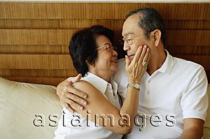 Asia Images Group - Older couple, hugging, woman with hand on man's face