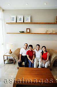 Asia Images Group - Two generation family, sitting in living room, looking at camera