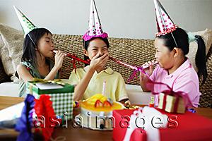 Asia Images Group - Three girls with noisemakers and party hats