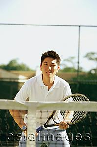 Asia Images Group - Man holding tennis racket, waiting to be served