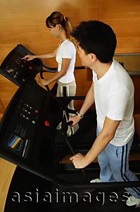 Asia Images Group - Couple in gym, on treadmill