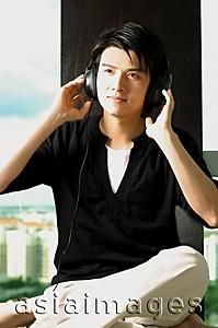 Asia Images Group - Man wearing headphones, listening to music