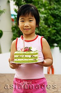 Asia Images Group - Young girl holding cake
