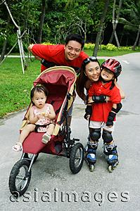 Asia Images Group - Family with two children at the park looking at camera