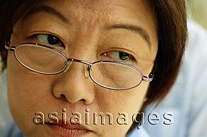 Asia Images Group - Woman with glasses, looking away, headshot