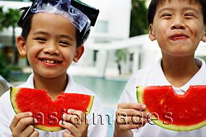 Asia Images Group - Two boys holding slices of watermelon, smiling