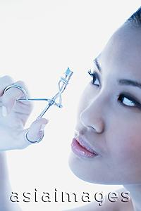 Asia Images Group - Woman using eyelash curler