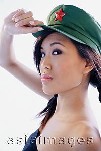 Asia Images Group - Woman touching cap, looking at camera