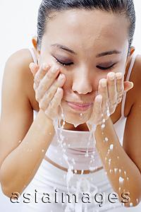 Asia Images Group - Woman splashing face with water