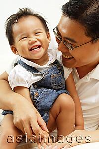 Asia Images Group - Father holding young daughter, smiling