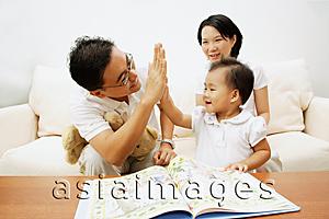 Asia Images Group - Family with one child, father giving daughter high five