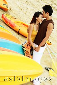 Asia Images Group - Couple on beach, man kissing woman's forehead