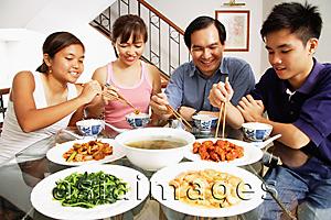 Asia Images Group - Family at home eating around dining table
