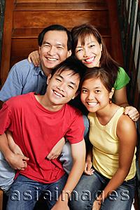 Asia Images Group - Family of four sitting on stairs, portrait