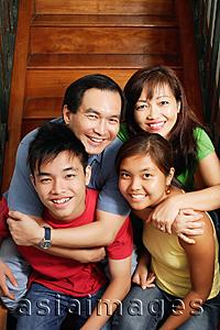 Asia Images Group - Father and mother sitting on stairs, hugging daughter and son, portrait