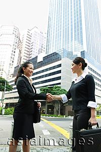 Asia Images Group - Two business women shaking hands