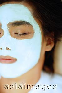 Asia Images Group - Young man with facial mask, eyes closed