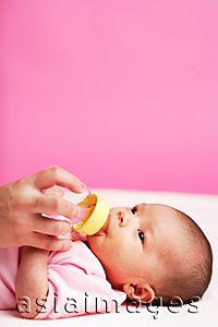 Asia Images Group - Baby lying down, drinking from bottle