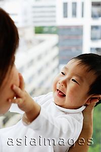 Asia Images Group - Baby boy touching mother's face