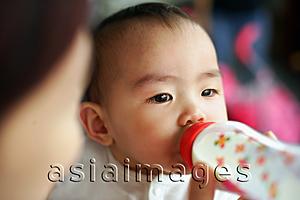 Asia Images Group - Baby girl drinking from bottle