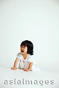 Asia Images Group - Baby girl crawling on floor, crying