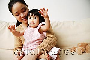Asia Images Group - Mother with young daughter on sofa