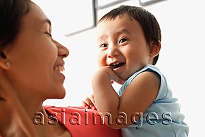 Asia Images Group - Mother carrying baby boy, boy with finger in mouth