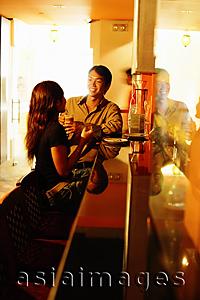 Asia Images Group - Couple sitting at bar counter, talking
